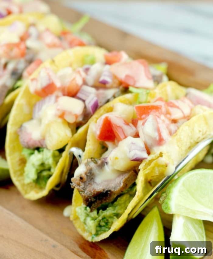 Sizzling Caribbean Steak Tacos 2 three finished tacos in a rack on a wood serving plate