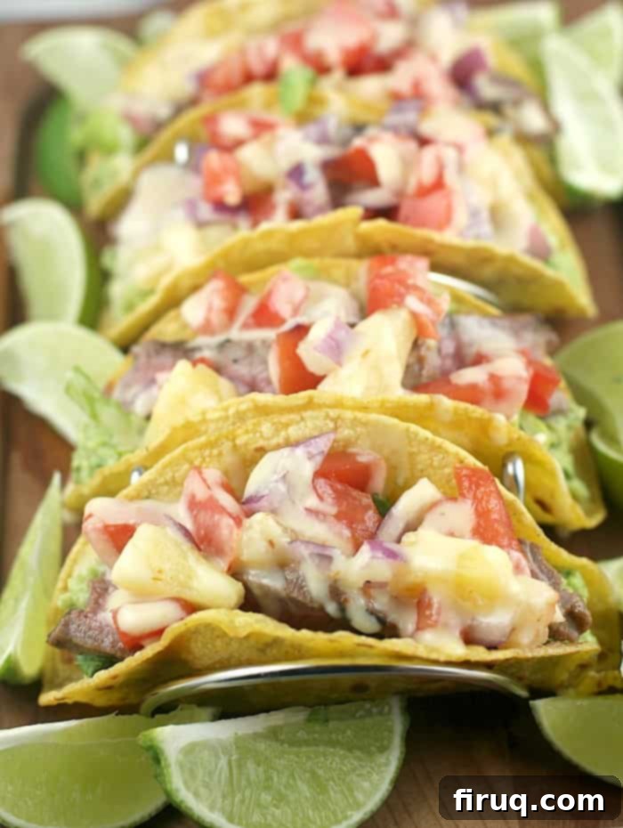 Sizzling Caribbean Steak Tacos 8 view of 4 assembled tacos in a rack