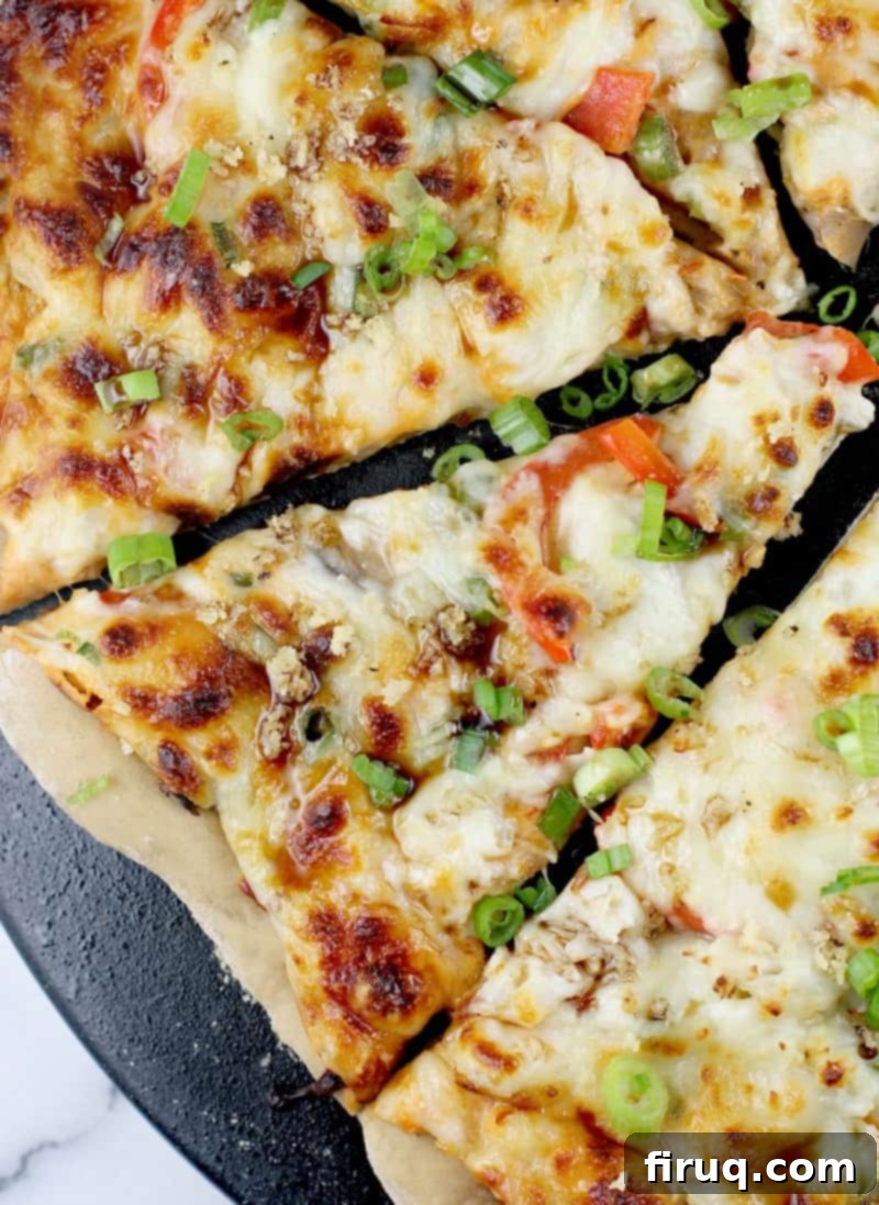 Creamy Crab Rangoon Pizza 3 top down view of sliced pizza on black surface