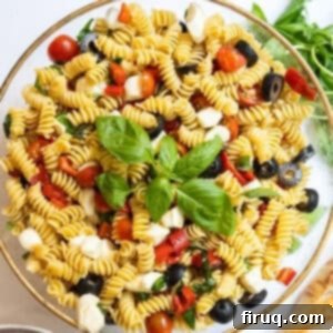 Zesty Italian Pasta Salad 10 Italian pasta salad in large bowl garnished with basil.