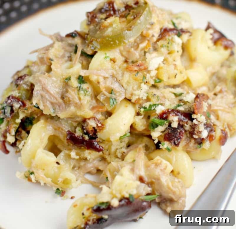 Hearty Pulled Pork Macaroni and Cheese Topped with Crispy Bacon and Fresh Herbs 4 Serving of Pulled Pork Macaroni and Cheese on a plate, highlighting the rich texture and topping