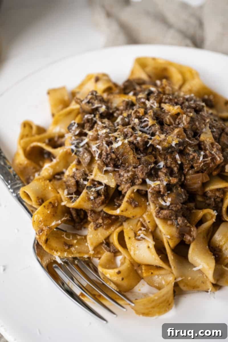 Effortless Lamb Ragu with Pappardelle 2 Lamb ragu over pappardelle on a small plate.