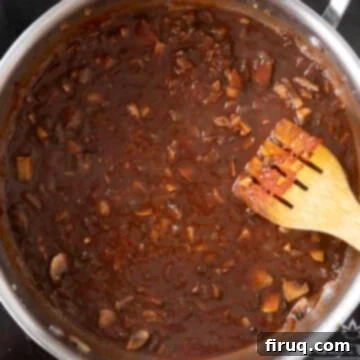 Effortless Lamb Ragu with Pappardelle 9 Red wine and chicken broth added to saucepan with vegetables.