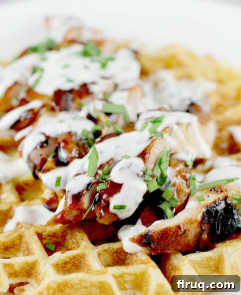 Honeyed Ale BBQ Chicken Waffle Stack 2 Honey Beer BBQ Chicken and Waffles, a close-up shot showing the grilled chicken, fluffy waffle, and ranch drizzle.