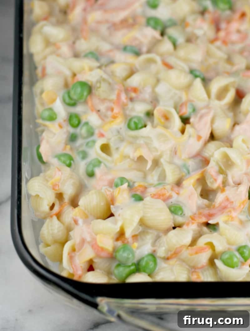 Golden Salmon Casserole 9 Uncooked fresh salmon casserole mixture in a glass baking dish, before adding the cracker topping