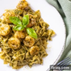 Velvety Pesto Shrimp Pasta 10 Shrimp over pesto pasta garnished with basil.