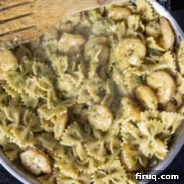 Velvety Pesto Shrimp Pasta 8 Pesto combined with pasta and shrimp in the pan.