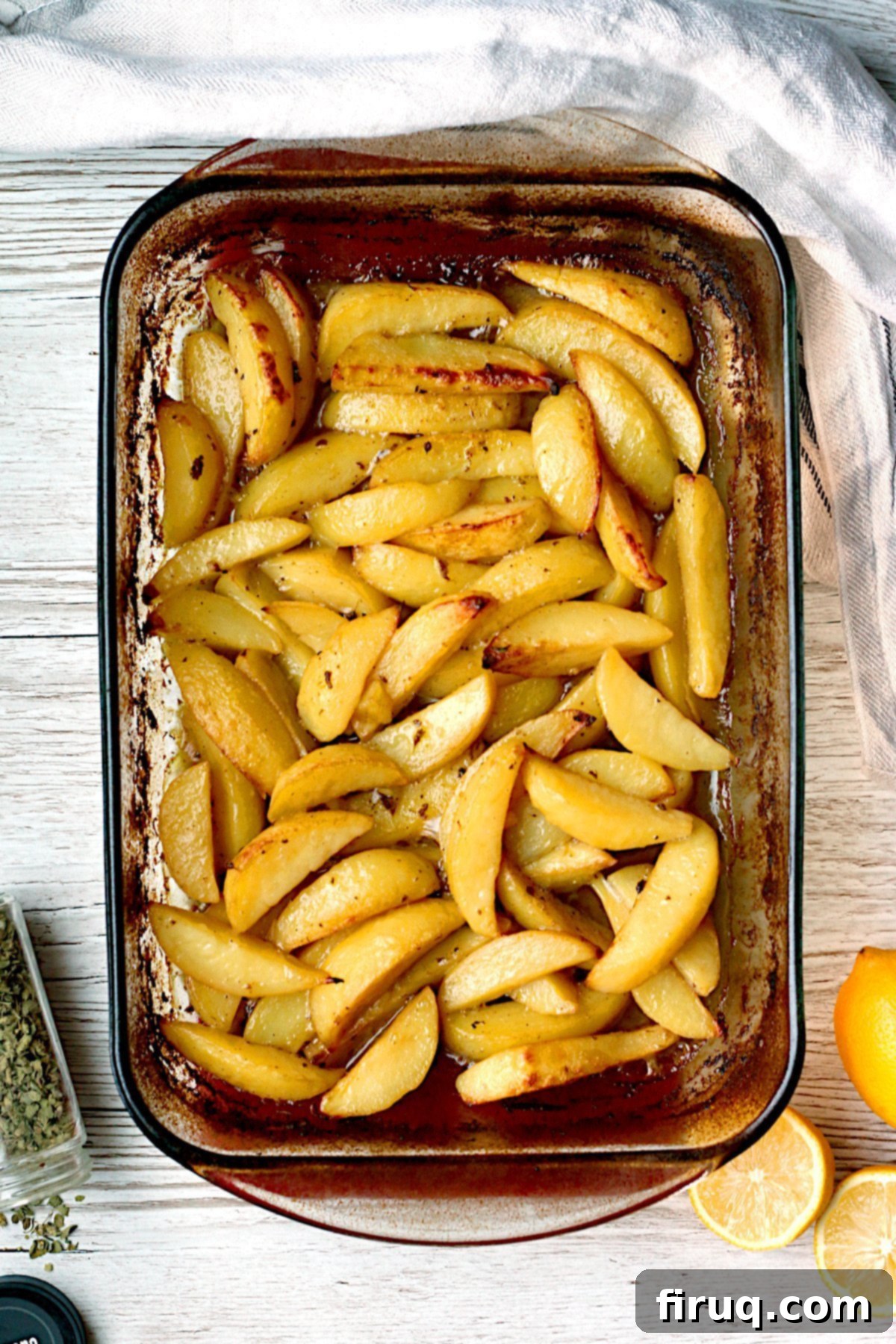 Delicious Greek Lemon Roasted Potatoes Overhead photo of Greek Lemon Potatoes in a glass baking dish.