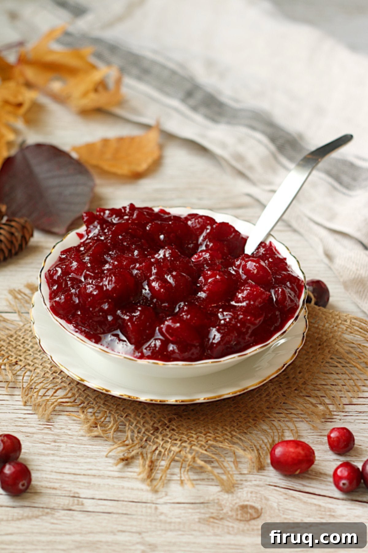 Vibrant Homemade Cranberry Sauce Ready to Serve Easy Homemade Cranberry Sauce in a white bowl, garnished with fresh cranberries and orange zest.