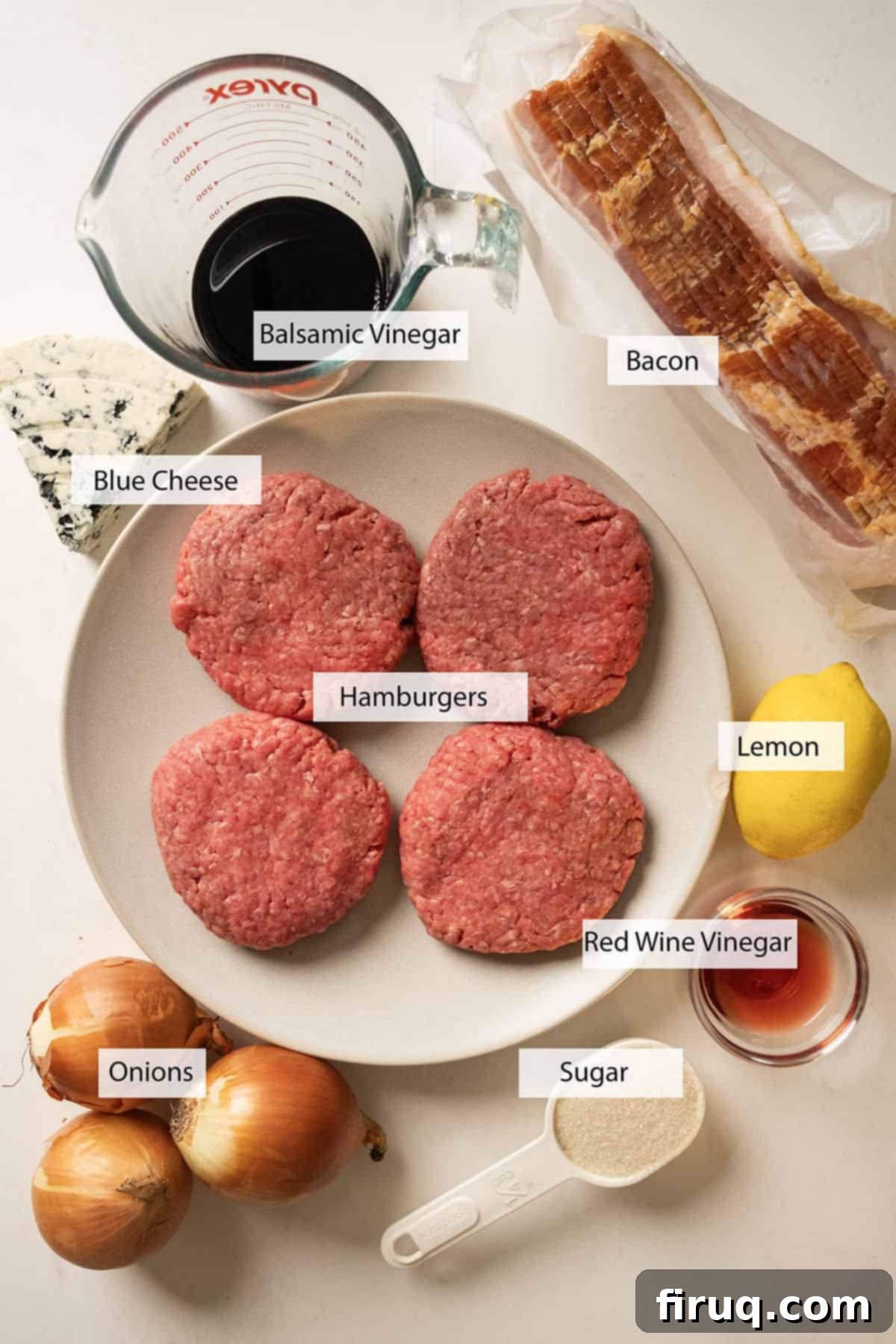 Sizzling Bacon & Bold Blue Cheese Burger 3 Fresh ingredients laid out for making the bacon blue cheese burger and onion jam, including onions, balsamic vinegar, blue cheese crumbles, ground beef, and bacon.