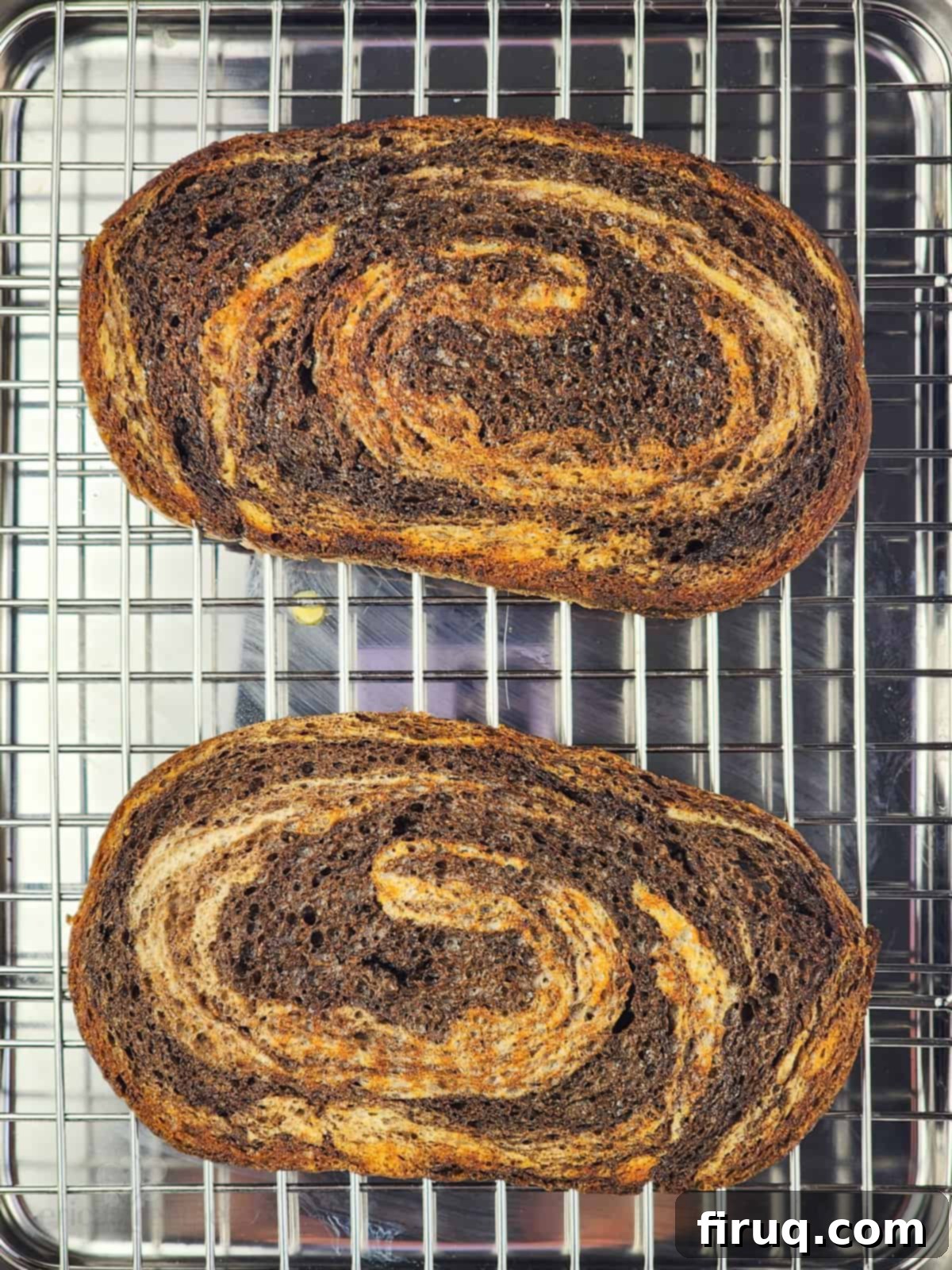 Golden Crab Melt Toast 4 Two slices of buttered marbled rye and pumpernickel bread toasting on a baking rack, ready for assembly.