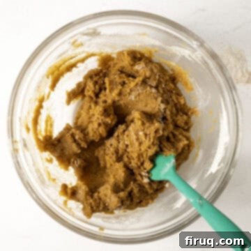 Soft and Chewy Pumpkin Spice Chocolate Chip Cookies 8 Fully combined, unmixed pumpkin cookie dough ready for chocolate chips in a large mixing bowl.