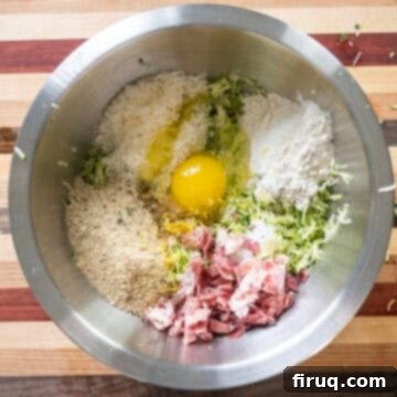 Guilt-Free Air Fryer Zucchini Fritters 7 All the dry and wet ingredients for zucchini fritters gathered in a large mixing bowl.