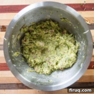 Guilt-Free Air Fryer Zucchini Fritters 8 The zucchini fritter mixture thoroughly combined in a bowl, showing the correct consistency.