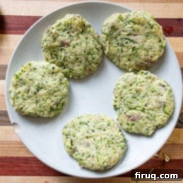 Guilt-Free Air Fryer Zucchini Fritters 9 Zucchini fritter mixture shaped into uniform patties, ready for air frying.