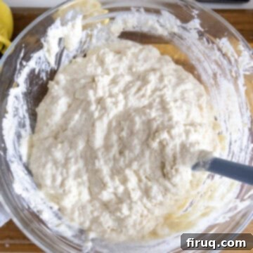 Bright Lemon Ricotta Blueberry Pancakes 7 Dry ingredients mixed into the wet ingredients in a bowl with butter.