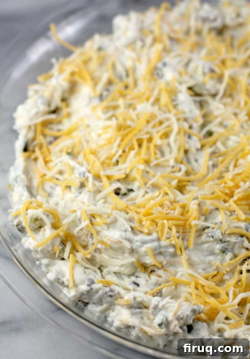Baking Hot Poblano and Sausage Dip Roasted Poblano and Sausage Dip baking in a pie dish, with a golden brown top.