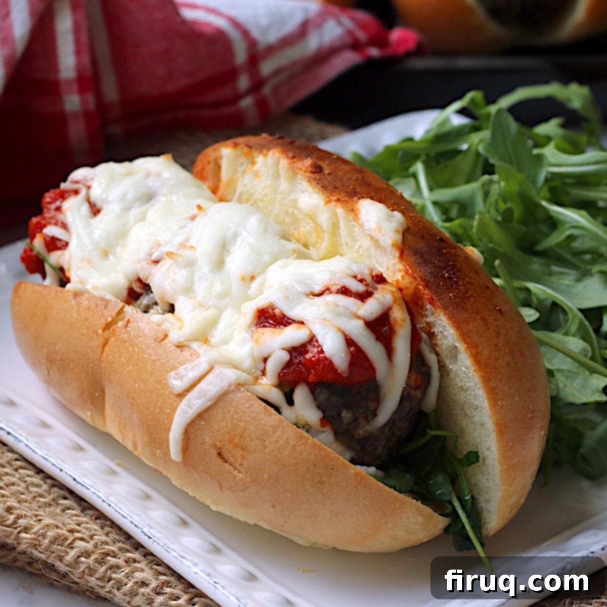 Irresistible Meatball Subs 2 Meatball sub on a square white plate.