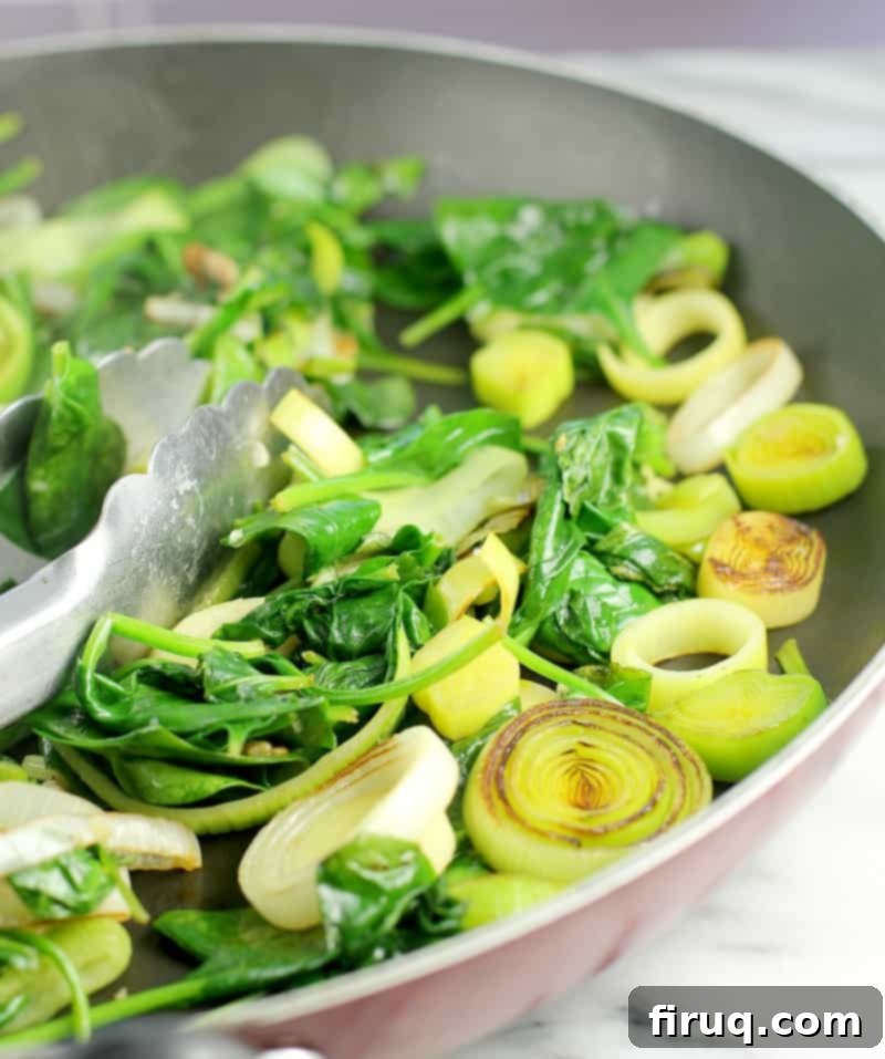 Gluten-Free Velvet Spinach & Leek Rotini 7 spinach and leeks cooking in a skillet