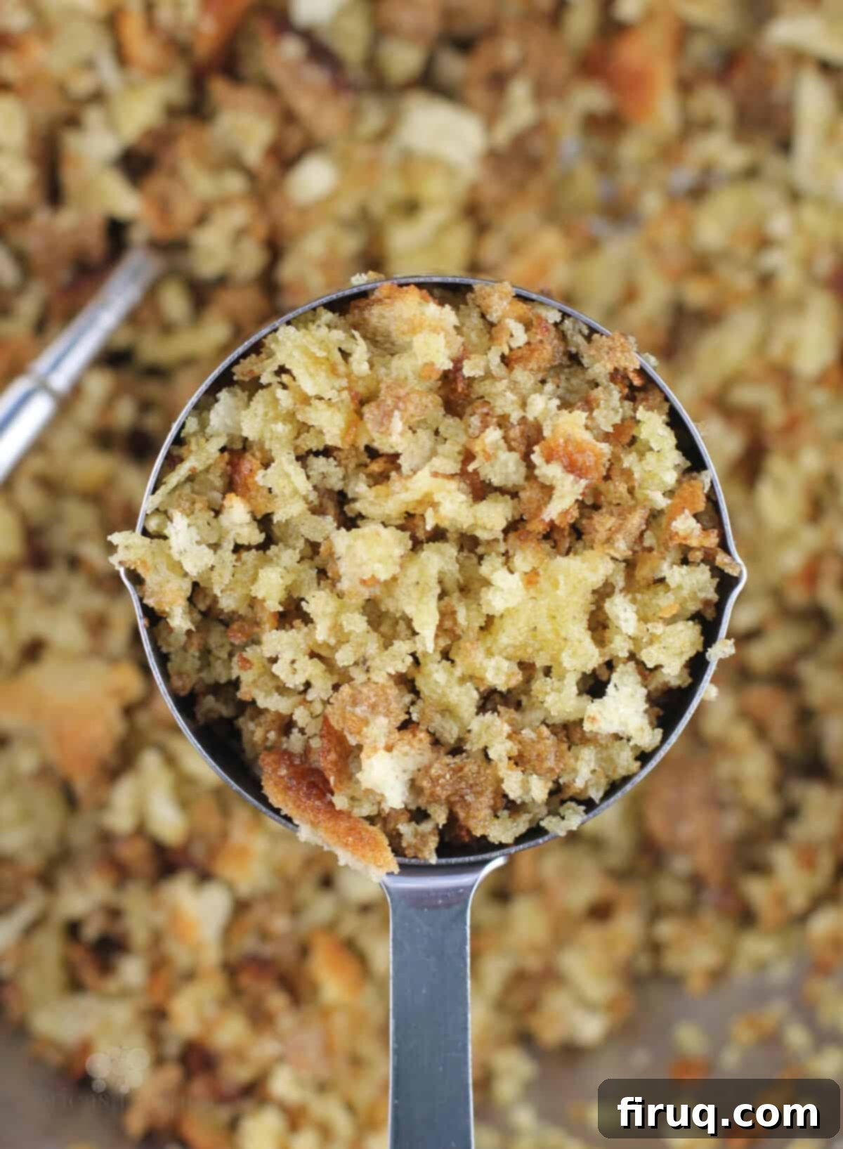 Comforting Chicken Zucchini Bake 6 A measuring cup filled with buttery stuffing mixture, reserved for the casserole topping.