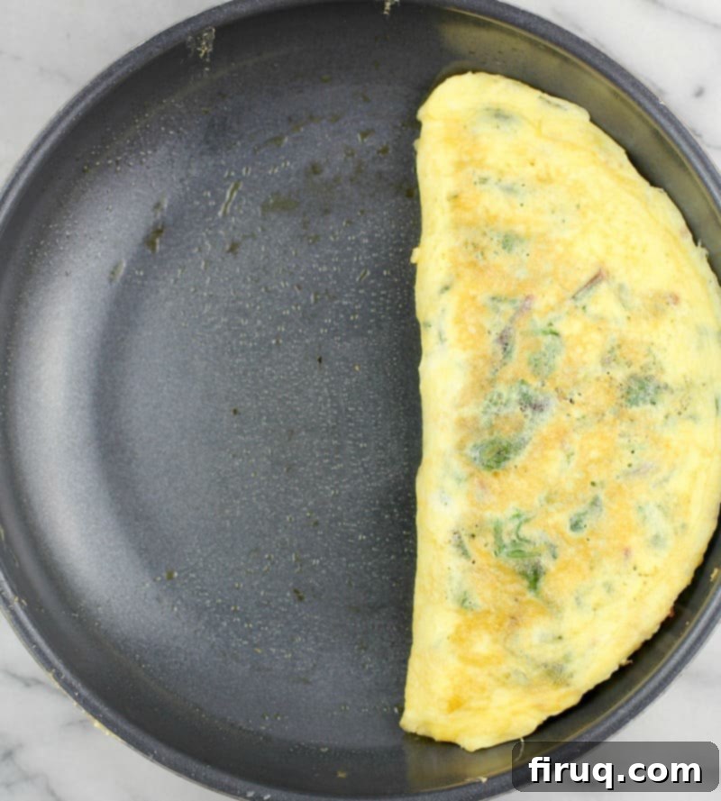 Keto Dairy-Free Bacon Jalapeno Popper Omelet 6 Top down view of the formed and cooked omelet in a skillet