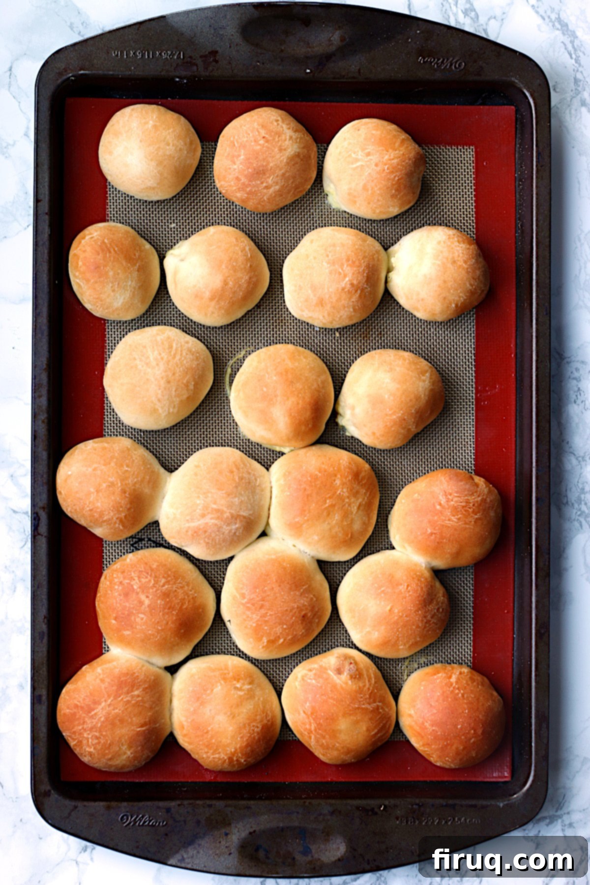 Freshly baked Ukrainian Perishke on a baking sheet Overhead photo of Ukrainian Perishke on a baking sheet, golden brown and perfectly risen.