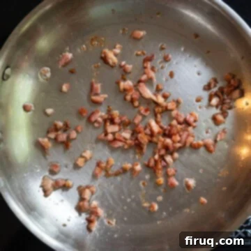 Garden Scramble Sandwich 5 pancetta frying in a frying pan.