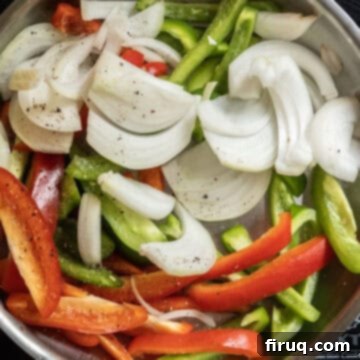 Garden Scramble Sandwich 6 raw peppers and onions sauteing in a frying pan.