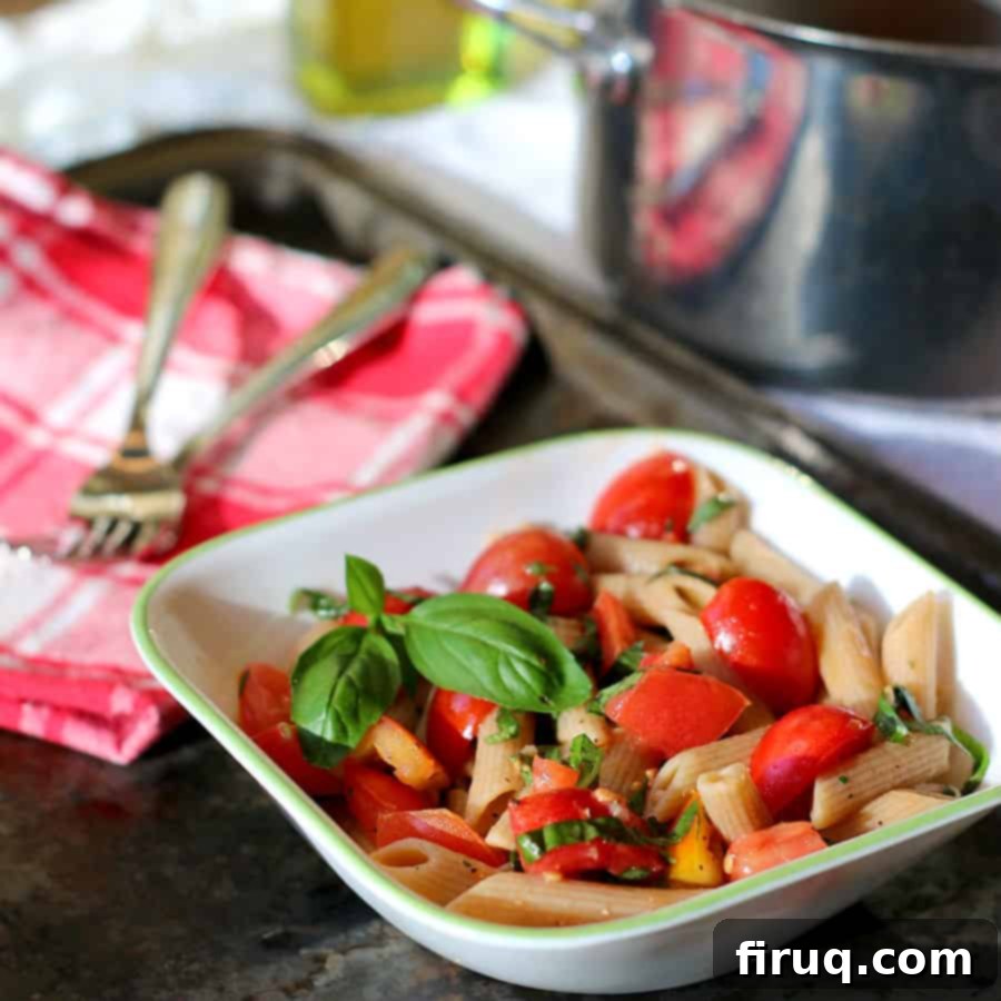 Wholesome Whole Wheat Pasta with Sun-Kissed Tomatoes and Garden Herbs 2 A vibrant bowl of Whole Wheat Pasta with Fresh Tomatoes and Herbs, a healthy and quick meal.