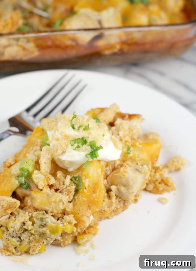 Unwrapped Keto Chicken Tamale Casserole 7 Finished Mexican chicken casserole plated on a white plate; bake dish is in the background