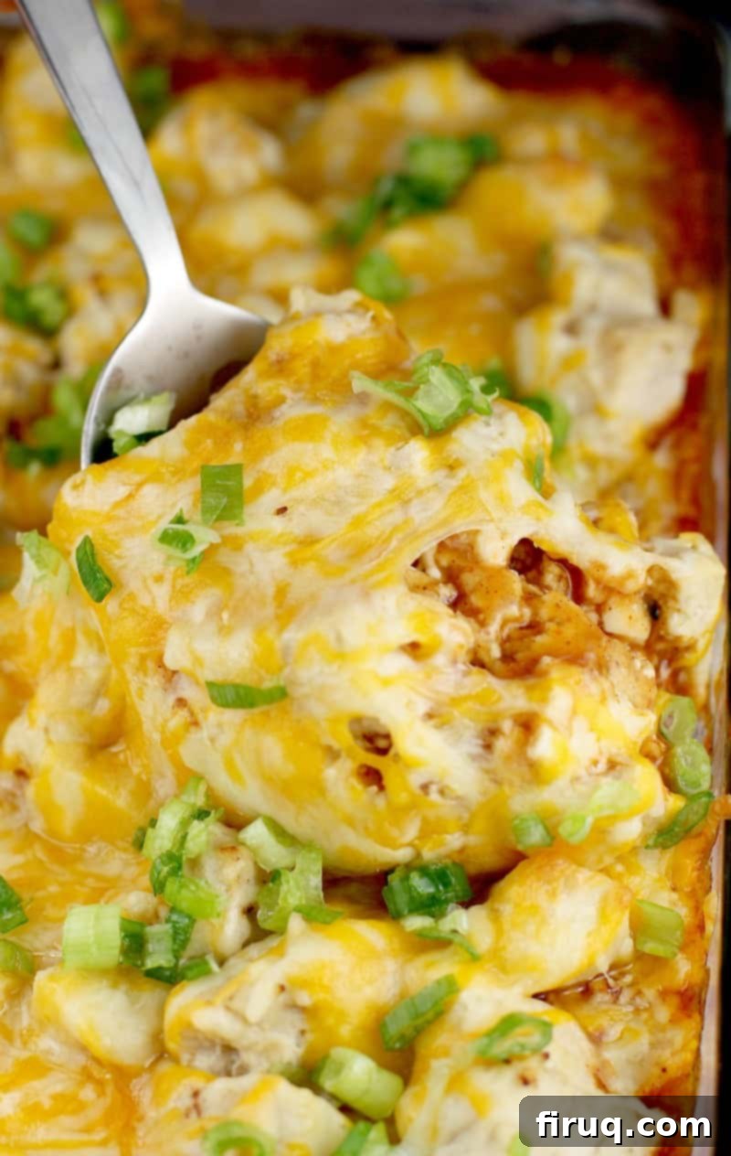 Unwrapped Keto Chicken Tamale Casserole 8 Finished tamale casserole in the bake dish with a large metal spoon scooping some up