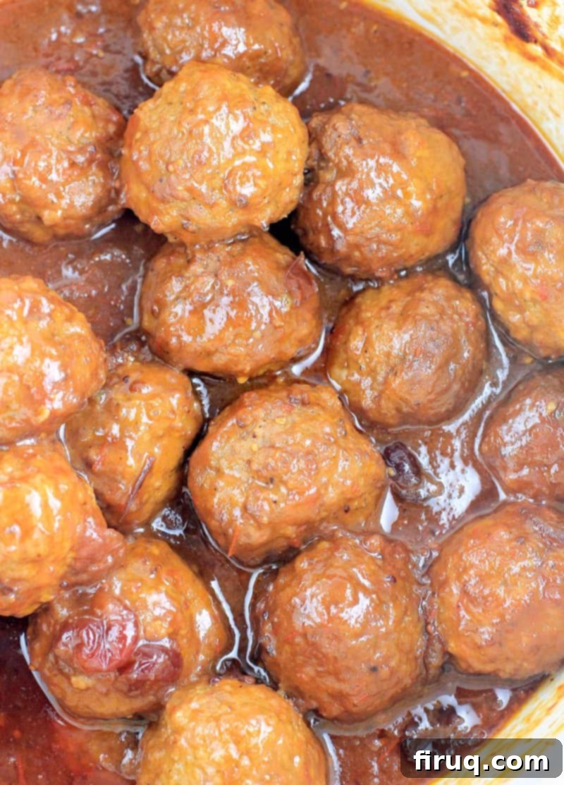 Slow Cooker Sweet Tangy Cranberry BBQ Meatballs 6 top down view of the saucy meatballs in a white crockpot