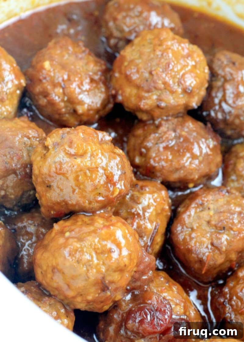 Slow Cooker Sweet Tangy Cranberry BBQ Meatballs 9 angled down view of the saucy meatballs in a white crockpot
