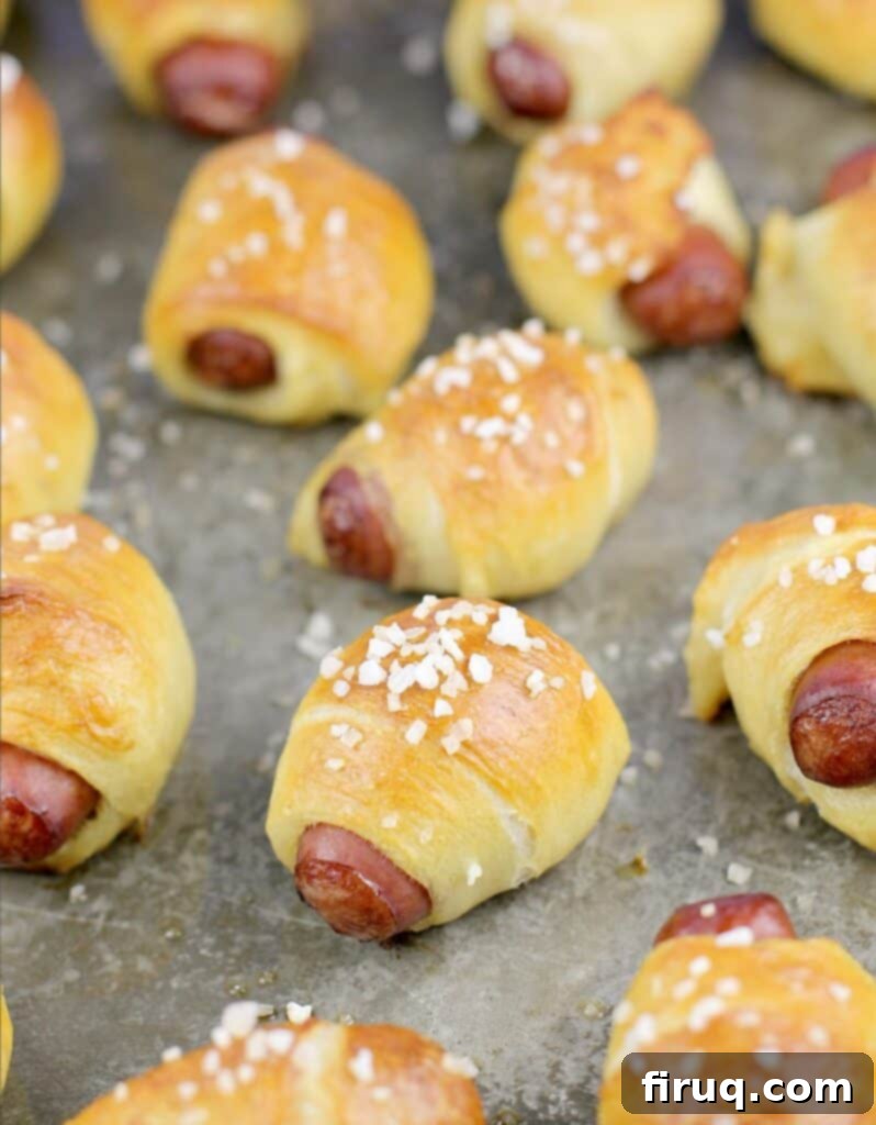 Golden Pretzel Piggy Bites with Tart Red Currant Dip 8 additional view of cooked pretzel bread wrapped smokies on a bake sheet