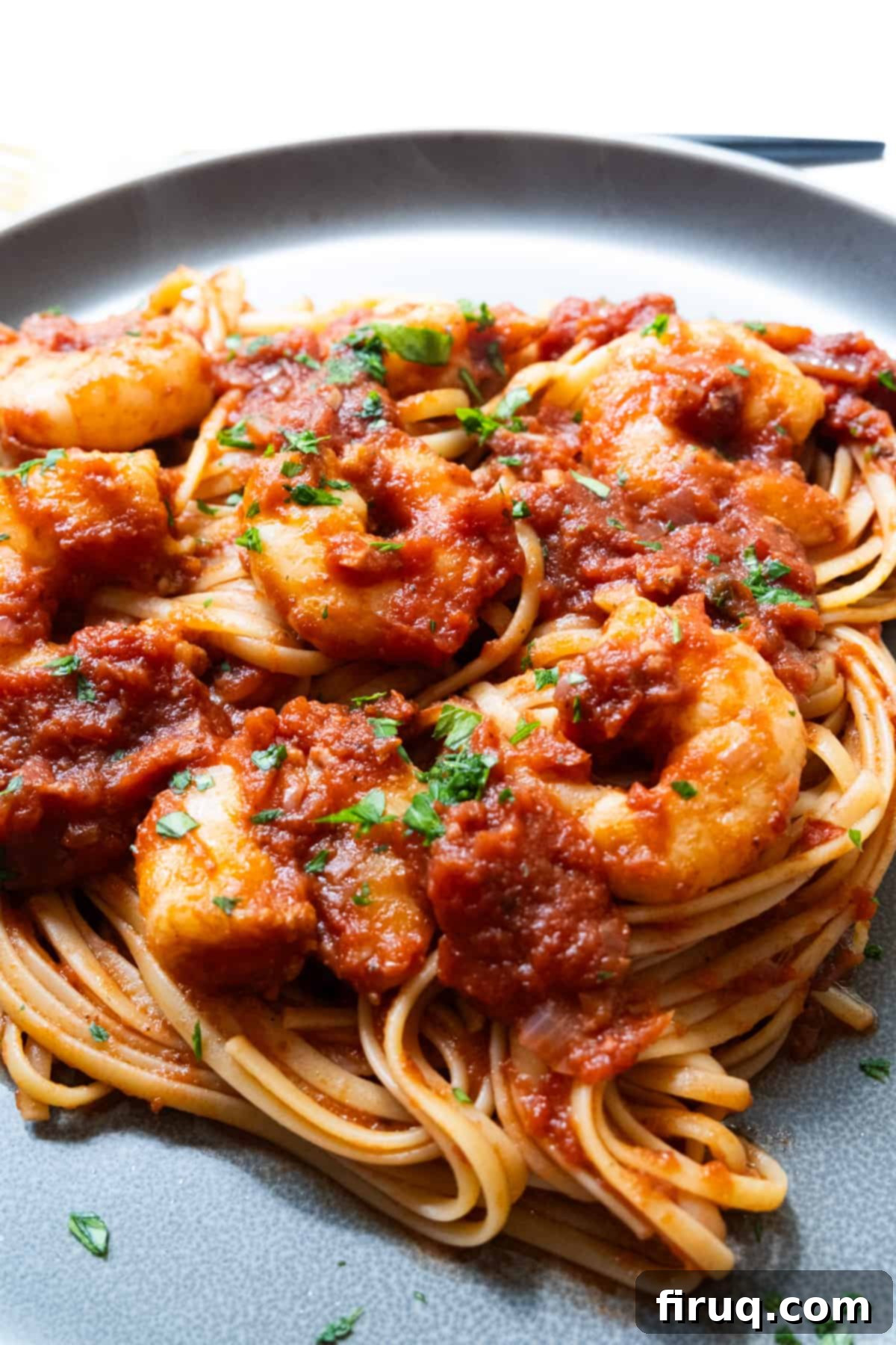 Fiery Shrimp Linguine Fra Diavolo 11 Shrimp fra diavolo with linguine on a plate.