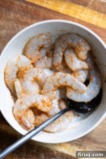 Fiery Shrimp Linguine Fra Diavolo 4 Seasoned shrimp with cayenne, garlic powder, salt and pepper in a bowl.