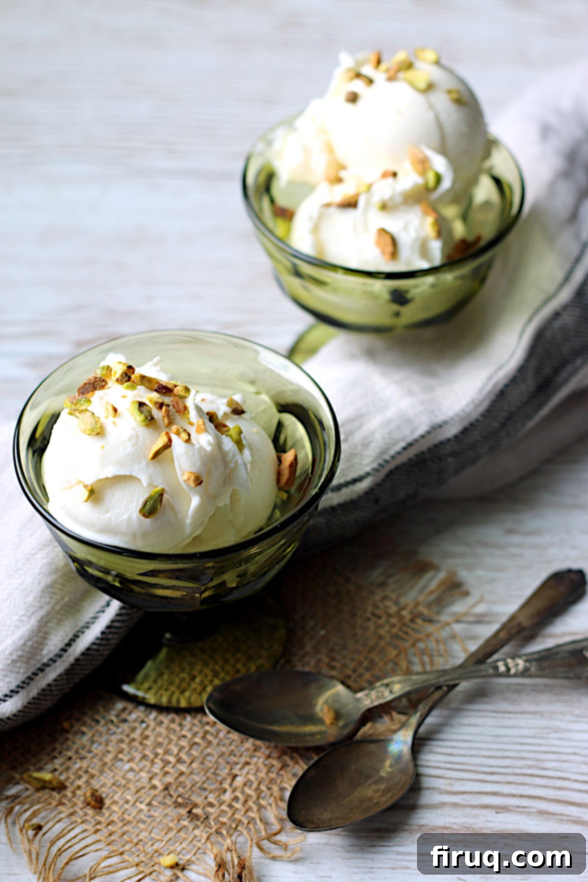 Booza-Inspired Ice Cream Servings Small green dessert dishes filled with creamy, light pink Booza-Inspired Ice Cream, ready to be enjoyed.