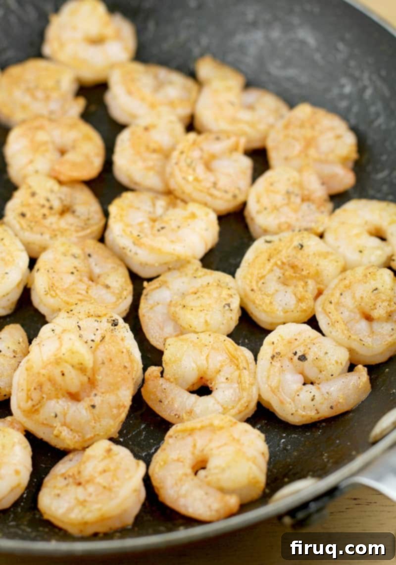 Zesty Creole Shrimp Deviled Eggs with Crispy Bacon 5 view into the skillet cooking the creole shrimp, seasoned and sizzling in olive oil