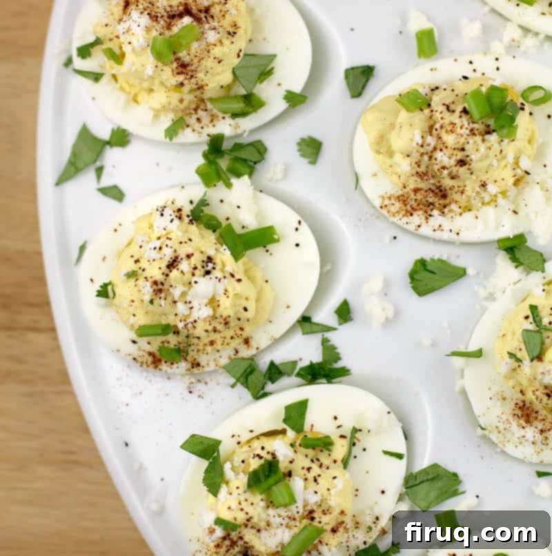 Elote Deviled Eggs 3 A vibrant top-down view of the finished corn and egg recipe, showcasing the colorful garnish and creamy filling in each deviled egg