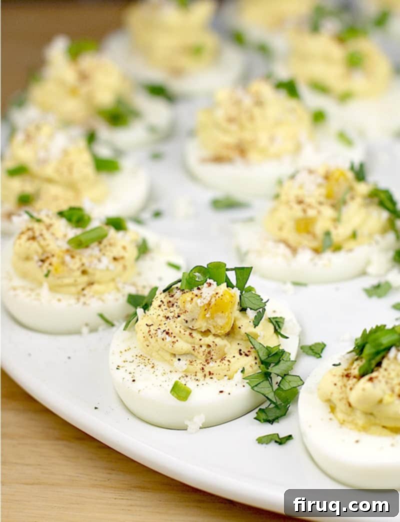 Elote Deviled Eggs 8 A stunning close-up of the finished corn and egg recipe, perfectly garnished and presented on a pristine white plate