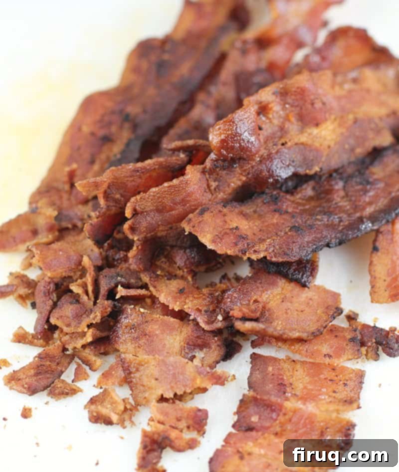 Bayou Mac and Cheese 5 chopped cooked bacon on a white cutting board