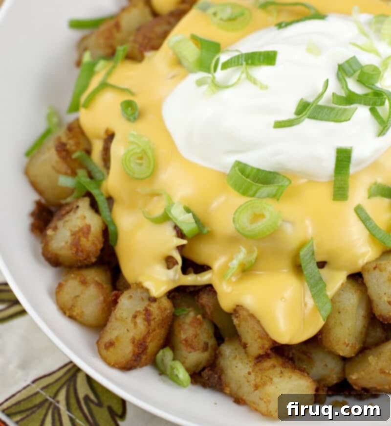 Zesty Cheesy Potato Bites 11 potatoes topped with cheese and sour cream in a white bowl