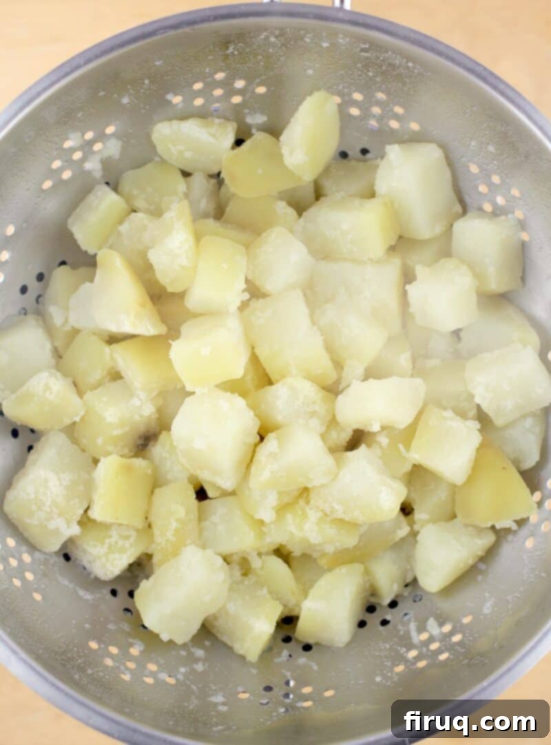 Zesty Cheesy Potato Bites 4 par-boiled potatoes draining in a colander
