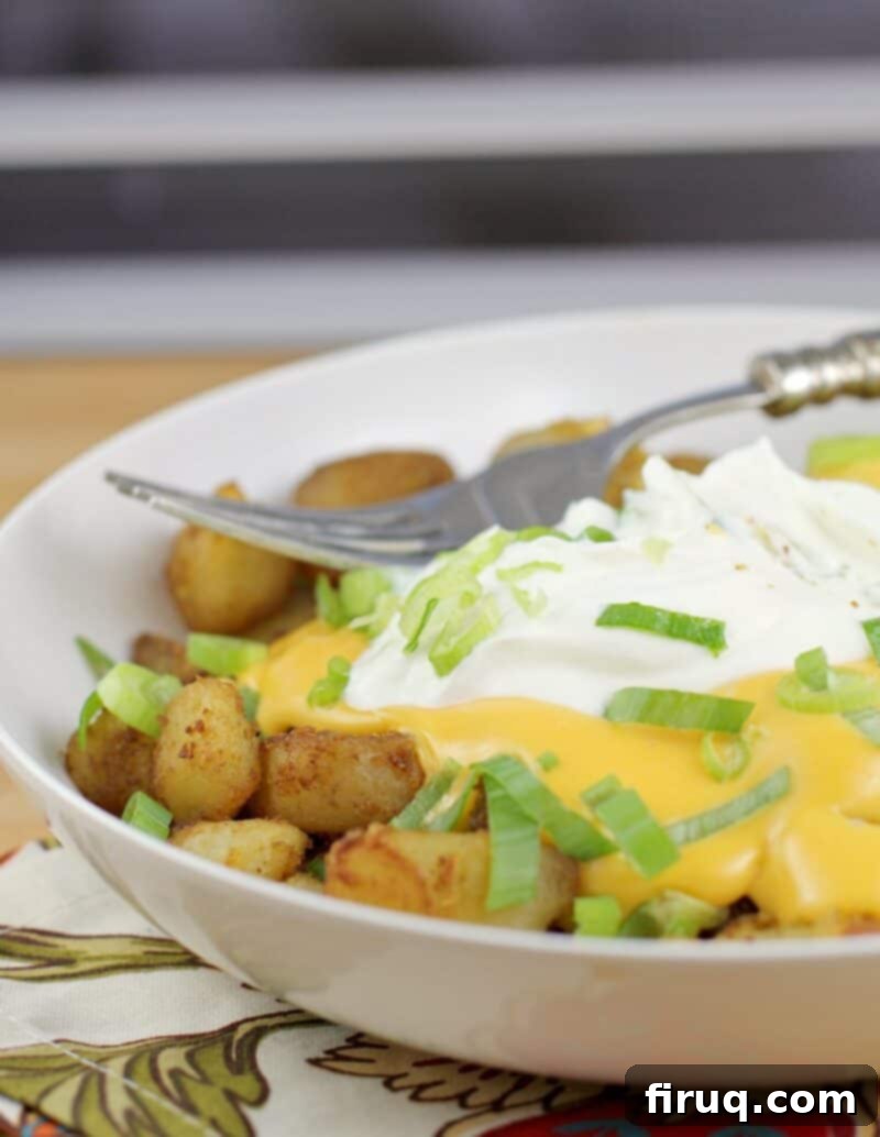 Zesty Cheesy Potato Bites 9 fiesta potatoes in a white bowl with fork on top
