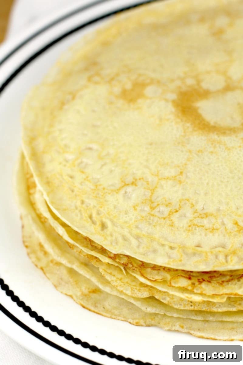 Easy Homemade Savory Crepes 11 round crepes piled on white plate
