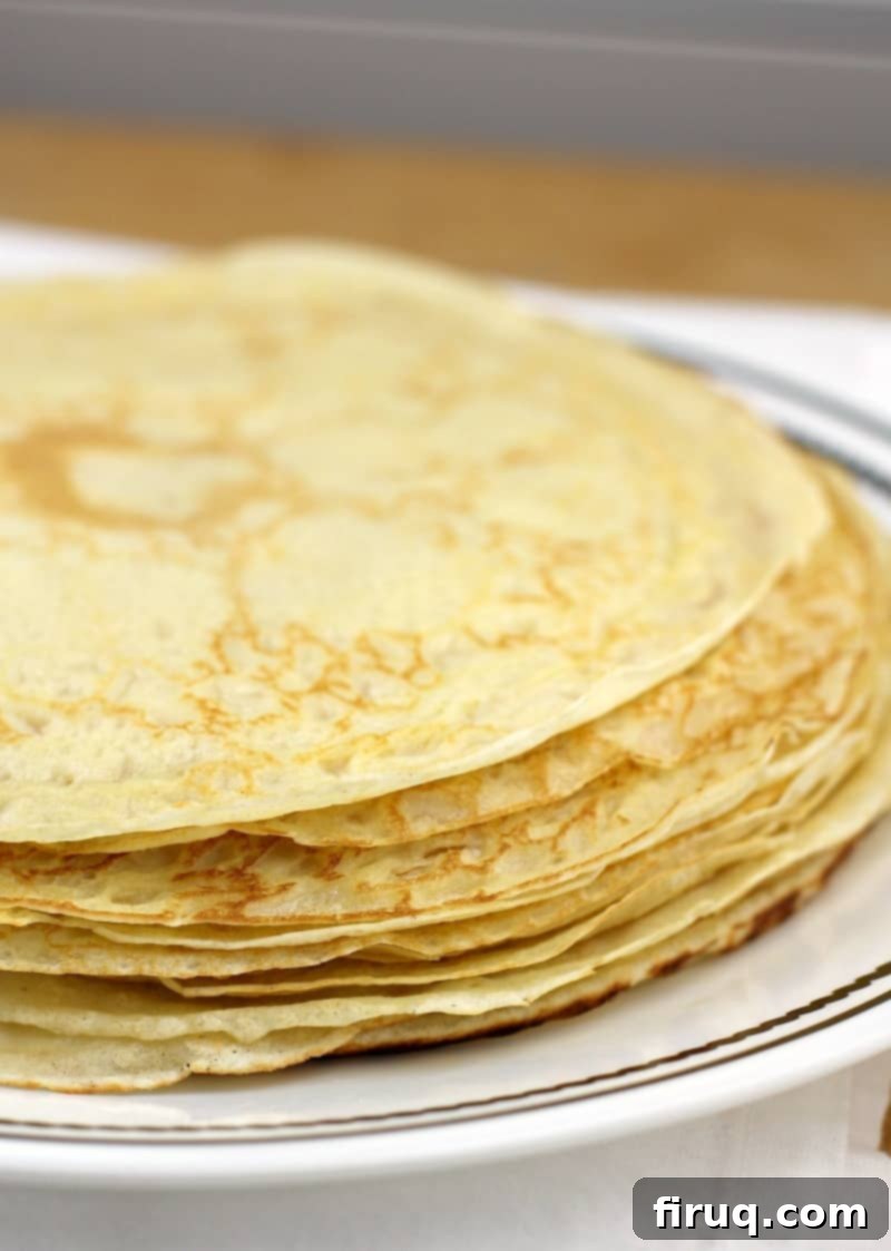 Easy Homemade Savory Crepes 3 stack of thin crepes on a white plate