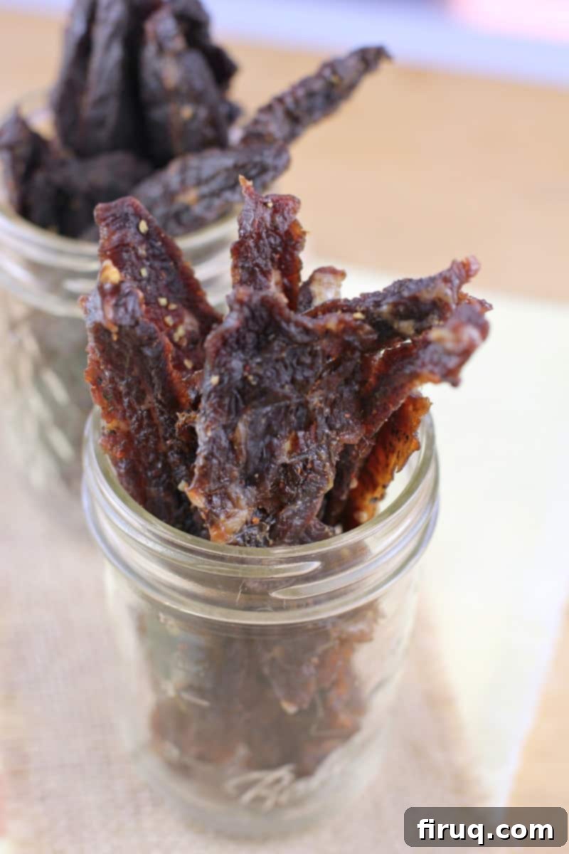 Homemade Beef Jerky Made Easy 4 glass mason jars filled with jerky