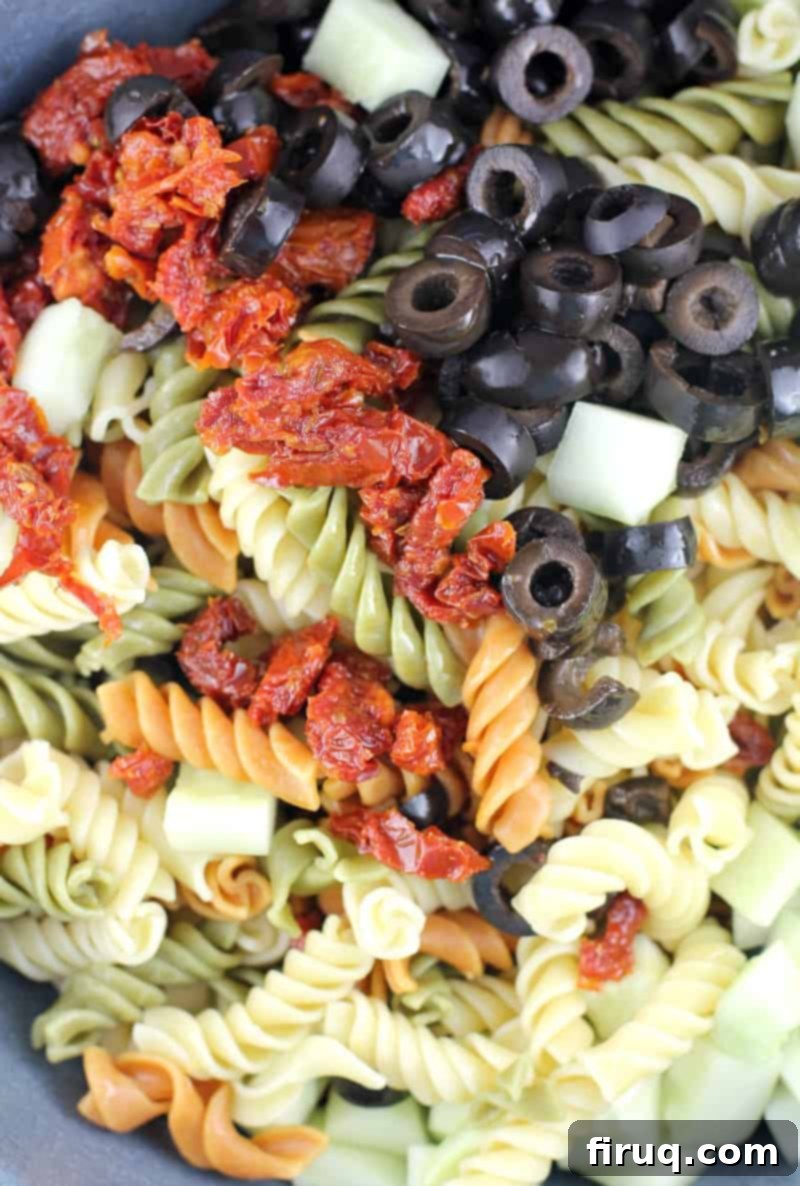 Vibrant Spinach Rotini Pasta Salad 4 ingredients for rotini salad in a bowl