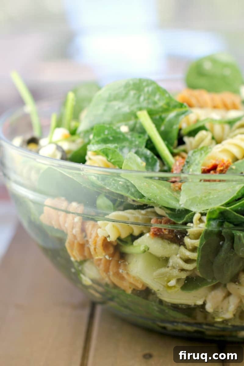 Vibrant Spinach Rotini Pasta Salad 8 glass bowl filled with salad