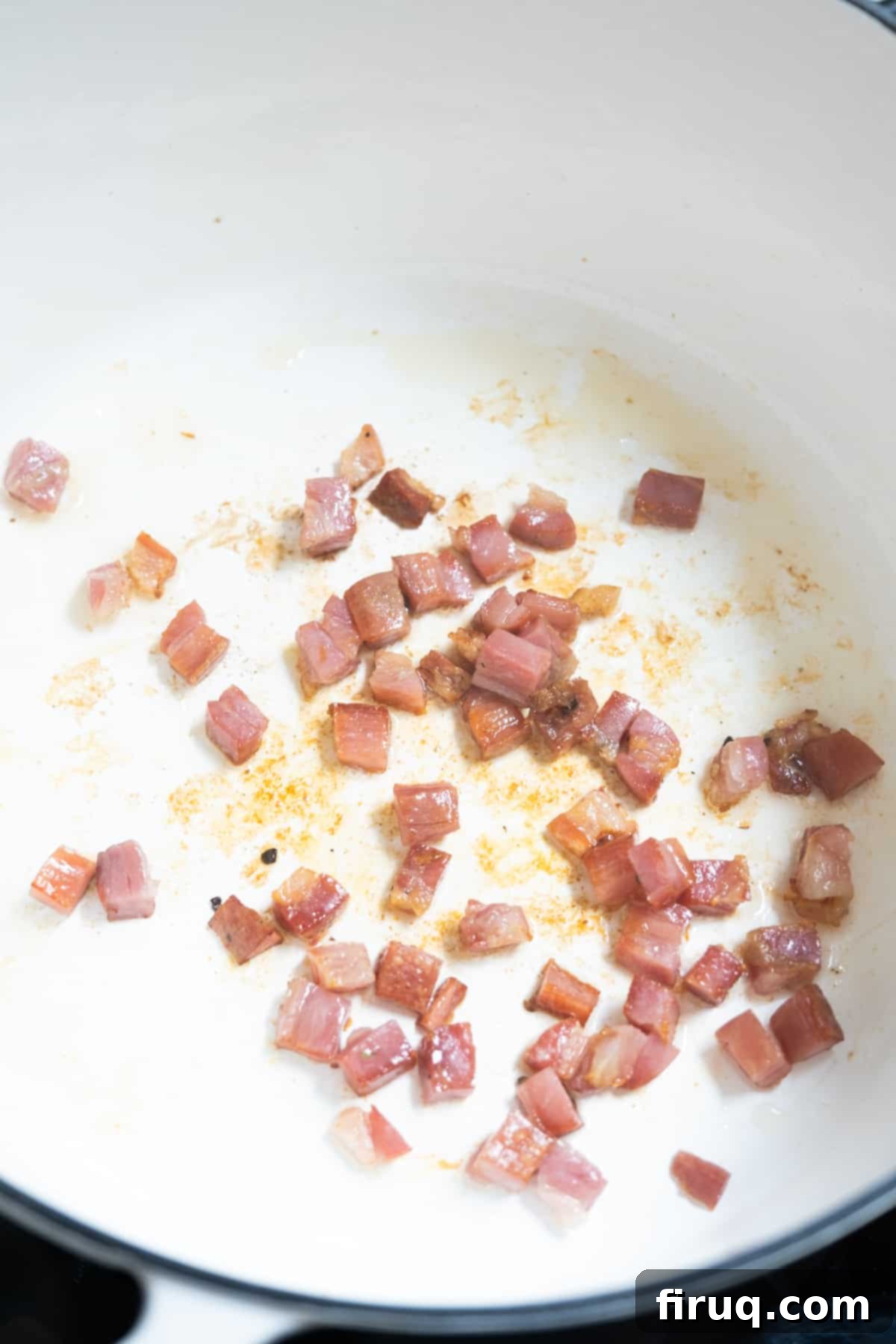 Hearty Italian Cabbage 5 Chopped pancetta frying in a Dutch oven, rendering fat and becoming golden brown